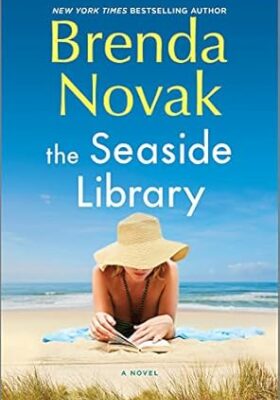 Zelienople Library A woman in a sun hat reads a book on a sandy beach with ocean waves behind her; the book cover is titled 